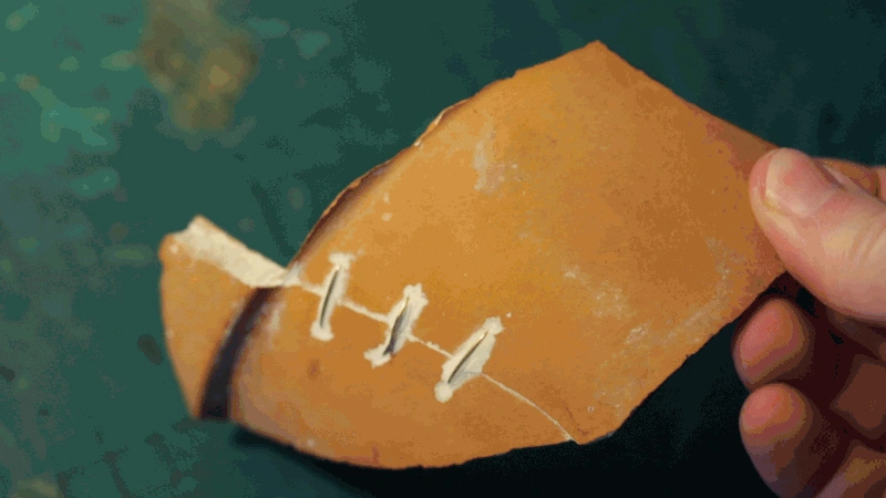 Tomas Brown lacing earthenware with brass for the Ware / Care blog, 2021
