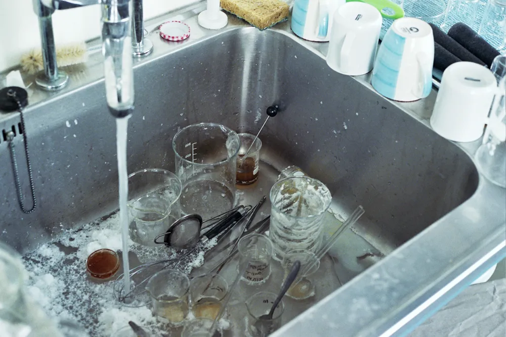 Tomas Brown cleaning up laboratory ware after cement experiments.