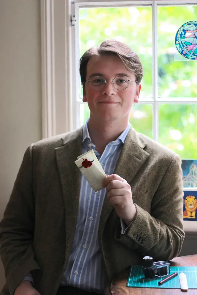 Tomas Brown at the end of the Unlocking History fellowship, holding one of his letterlocking simulacra